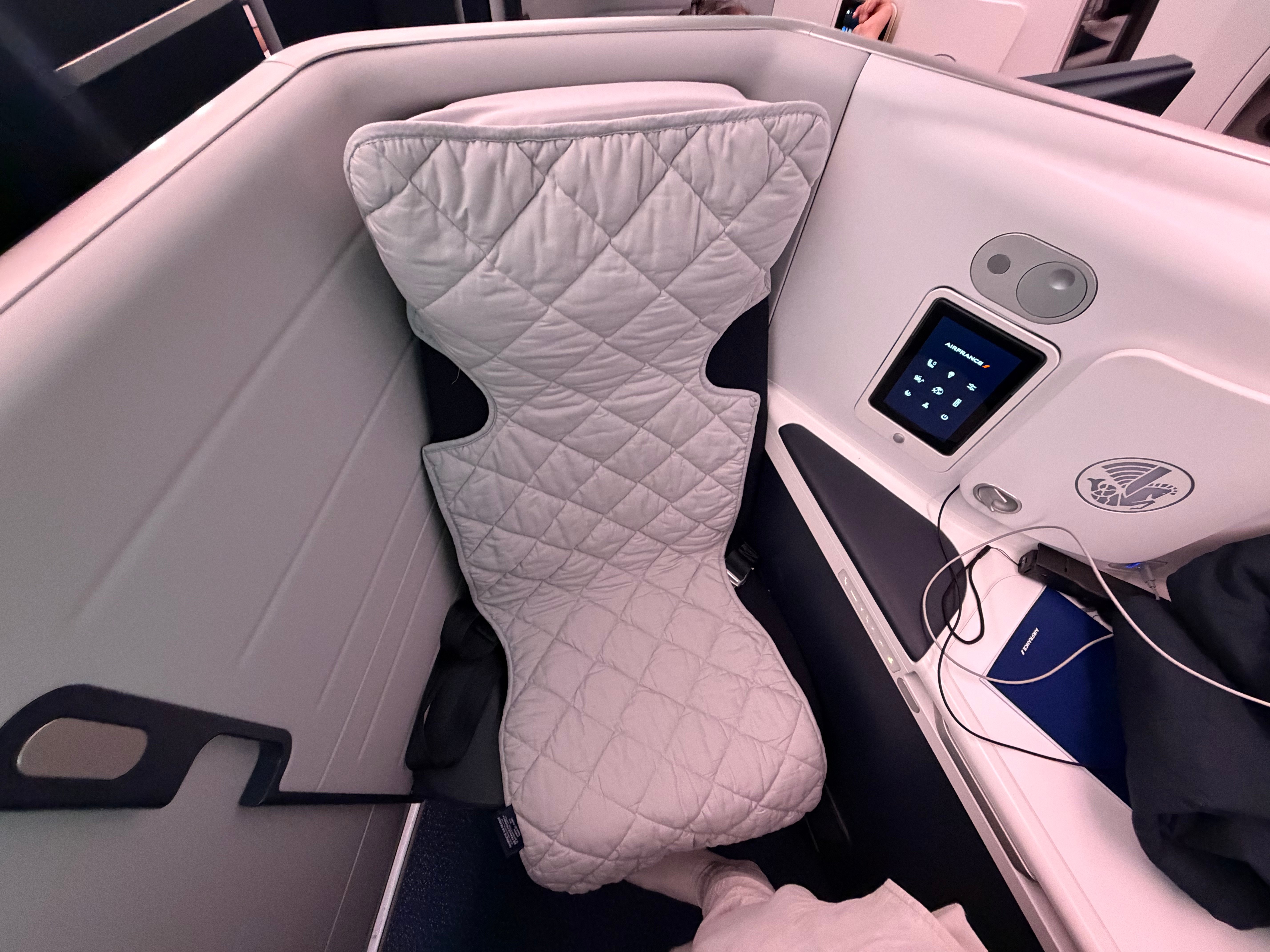 Pillow and mattress pad on the fully flat seat.