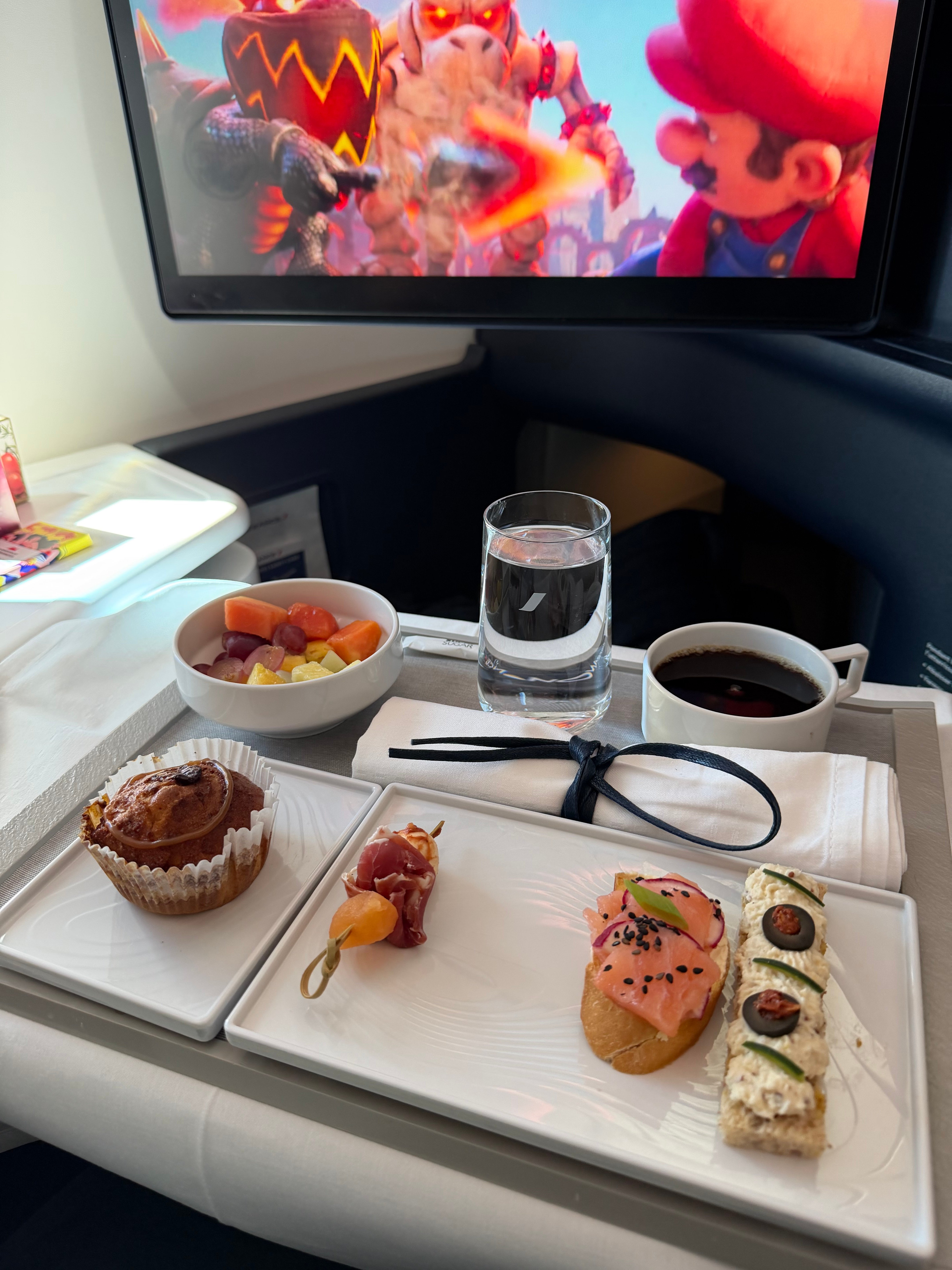 Meal tray and entertainment screen before arrival.