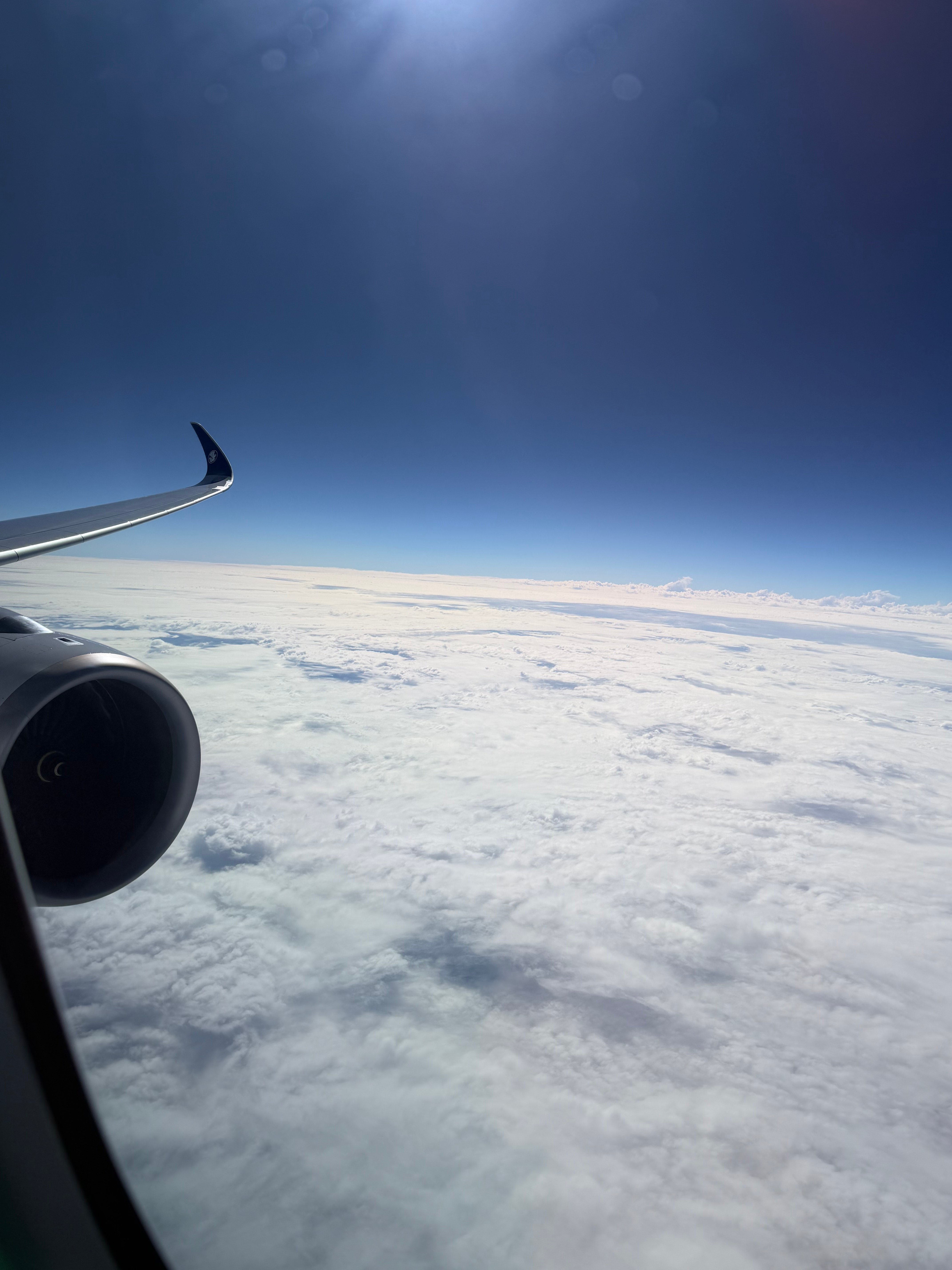 A350 wing above a layer of clouds.