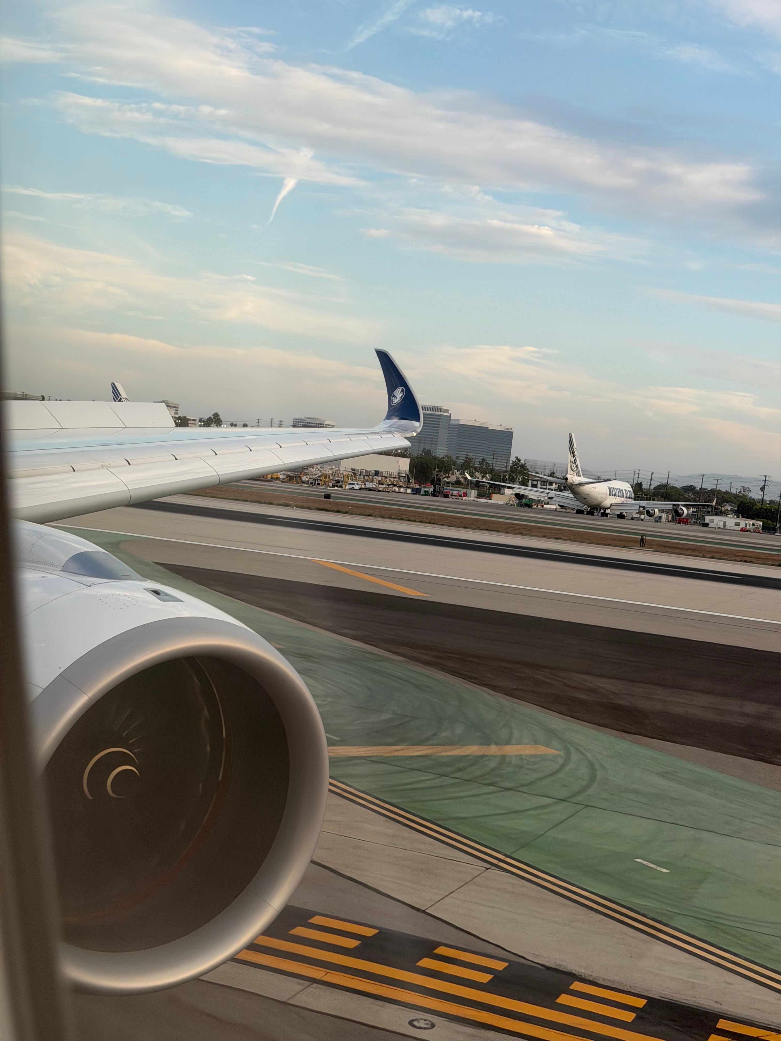 A350 wing and nearby aircraft while taxiing at LAX.