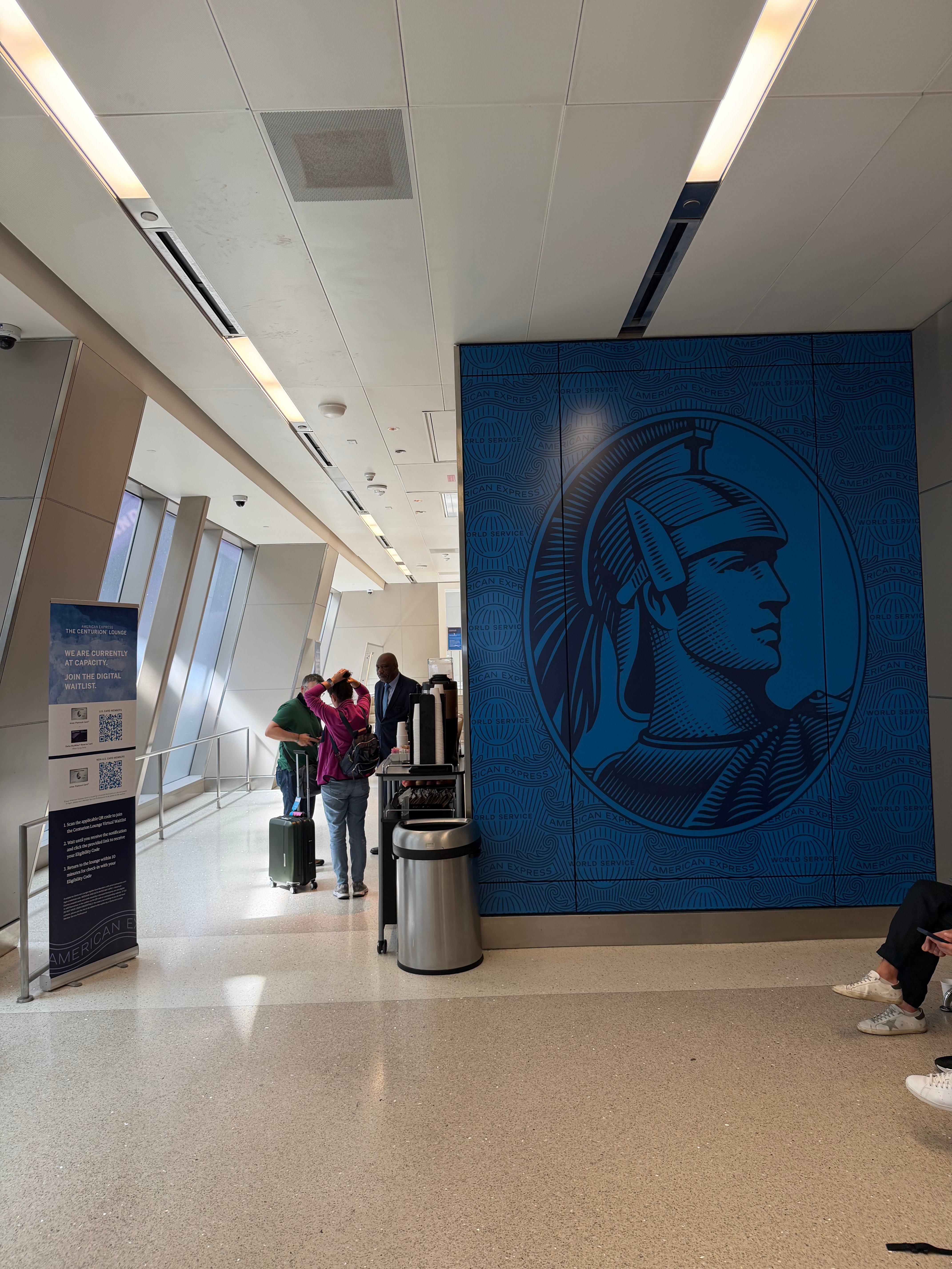 Passengers waiting in the corridor outside the Centurion Lounge at LAX.