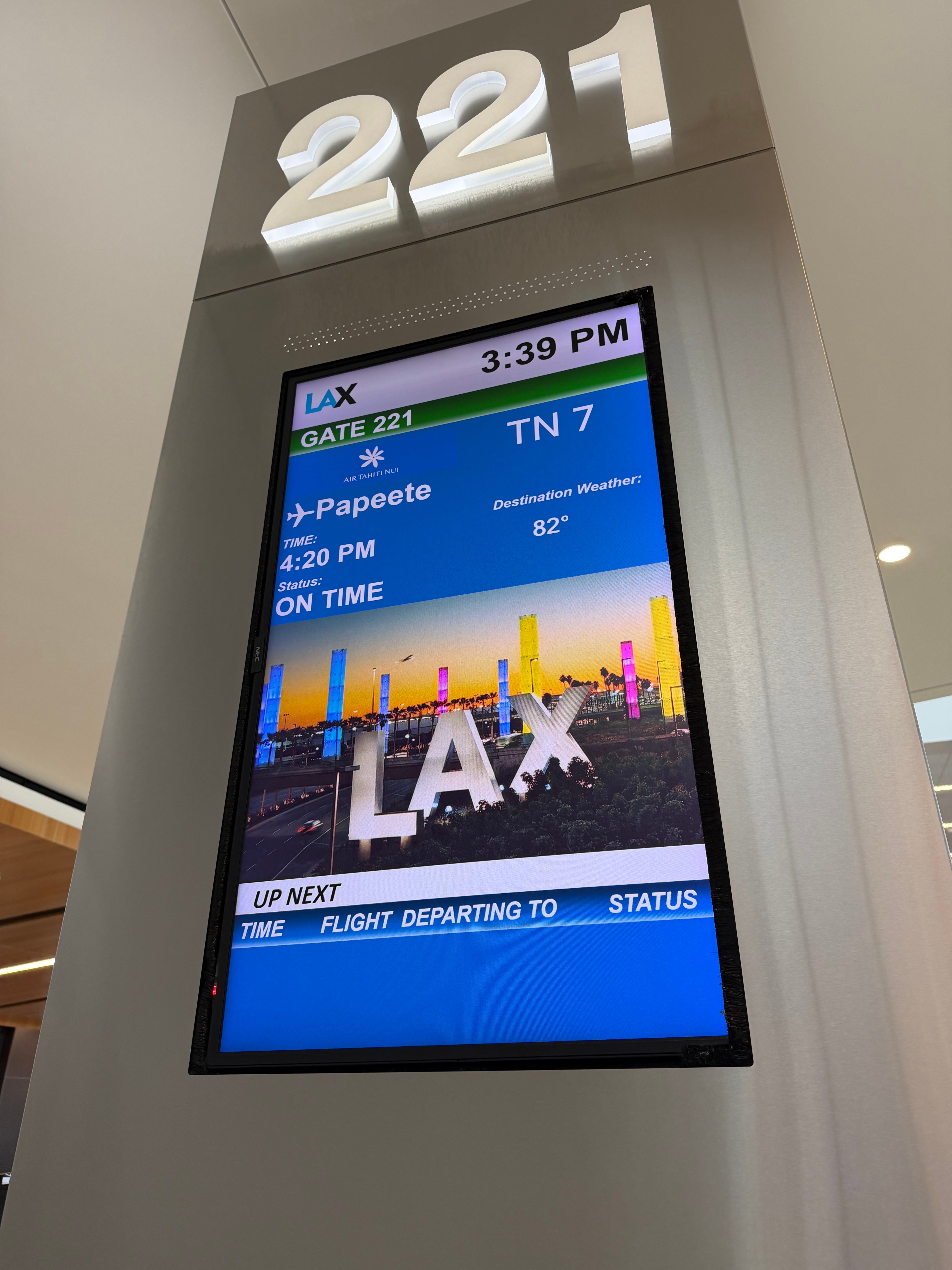 Gate 221 screen showing Air Tahiti Nui flight TN7 from Los Angeles to Papeete.