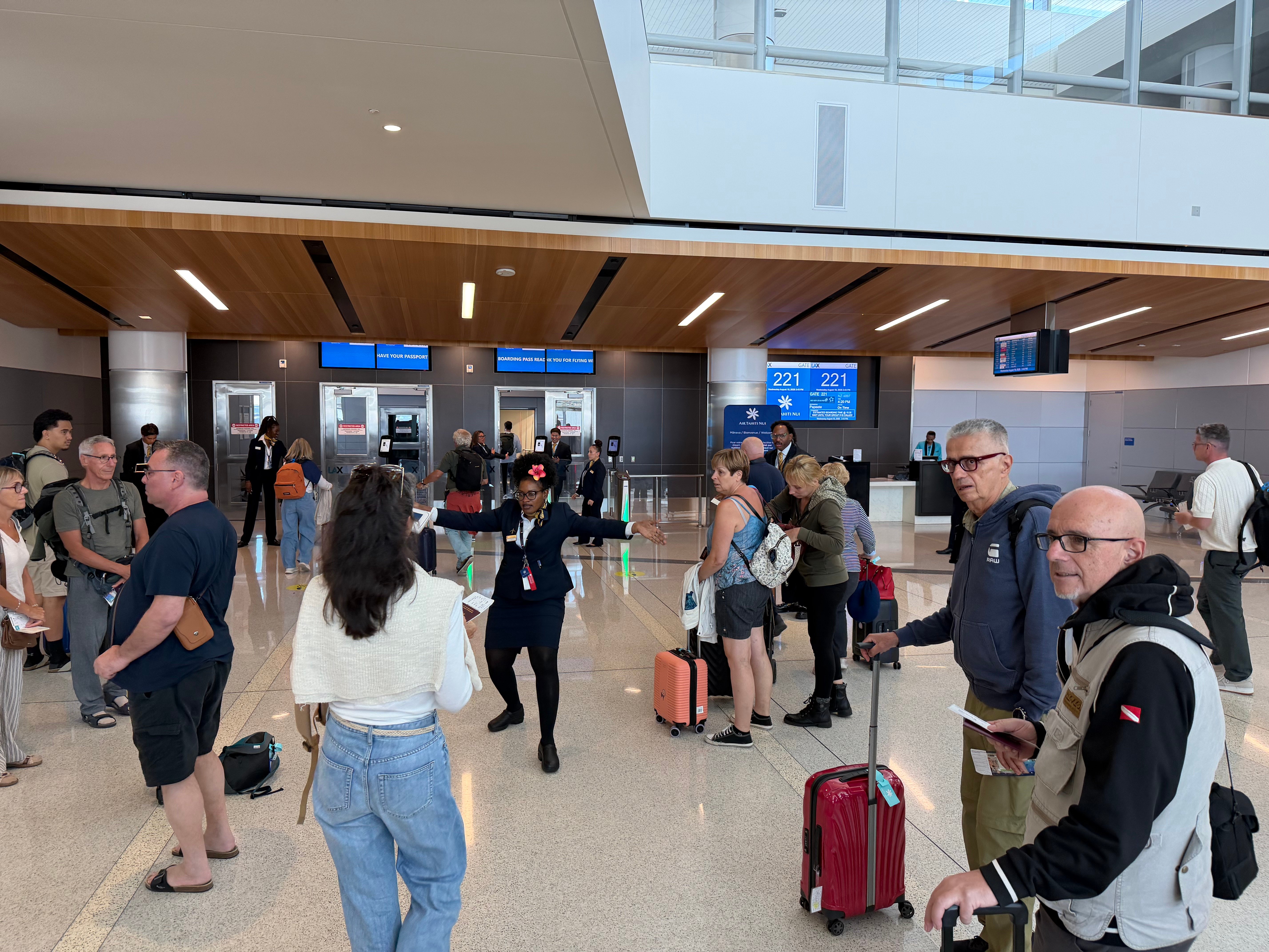Crowded boarding area at gate 221 before the Air Tahiti Nui flight to Papeete.