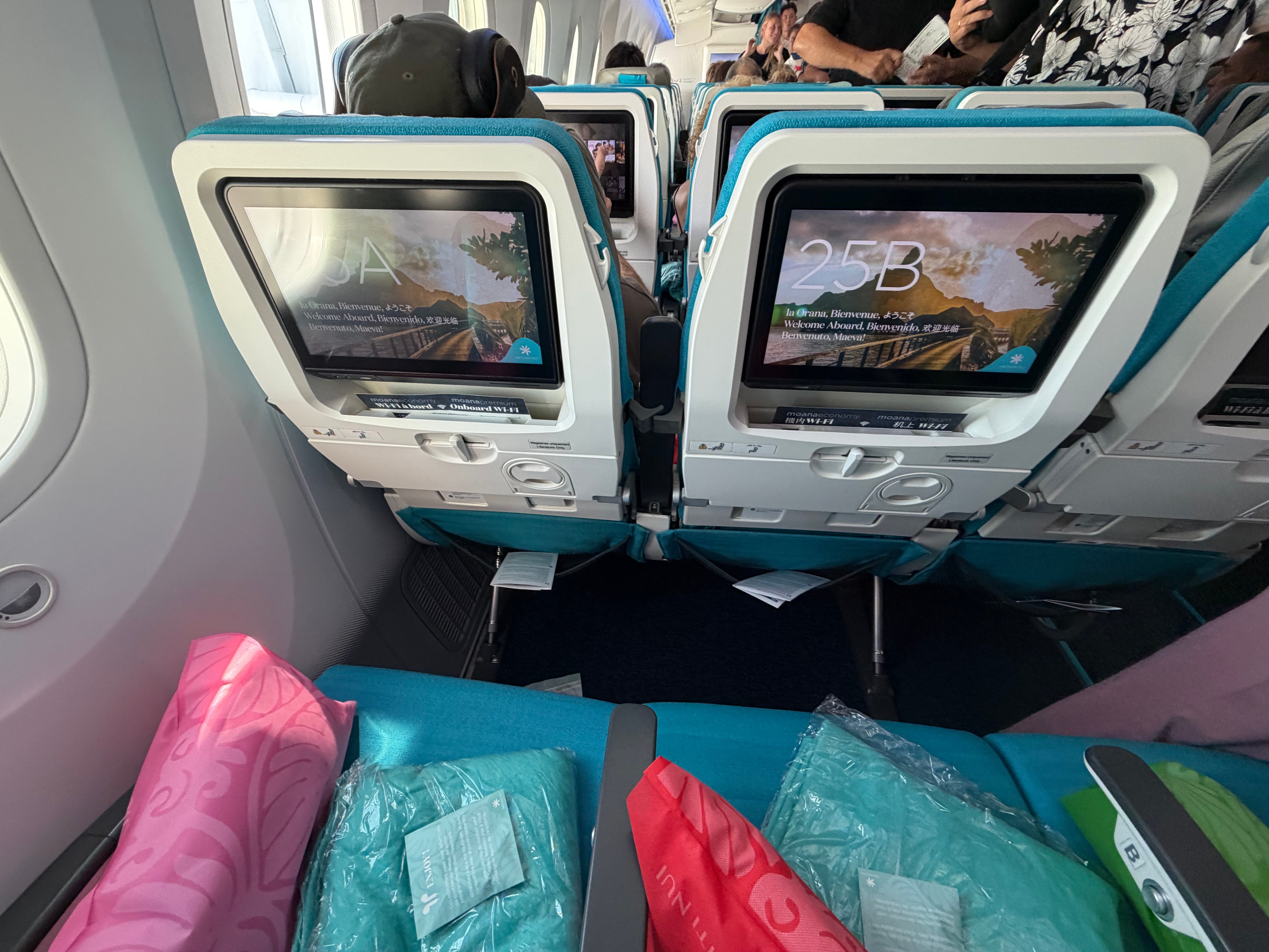 Seatback screens and legroom in the Air Tahiti Nui Moana Economy cabin.