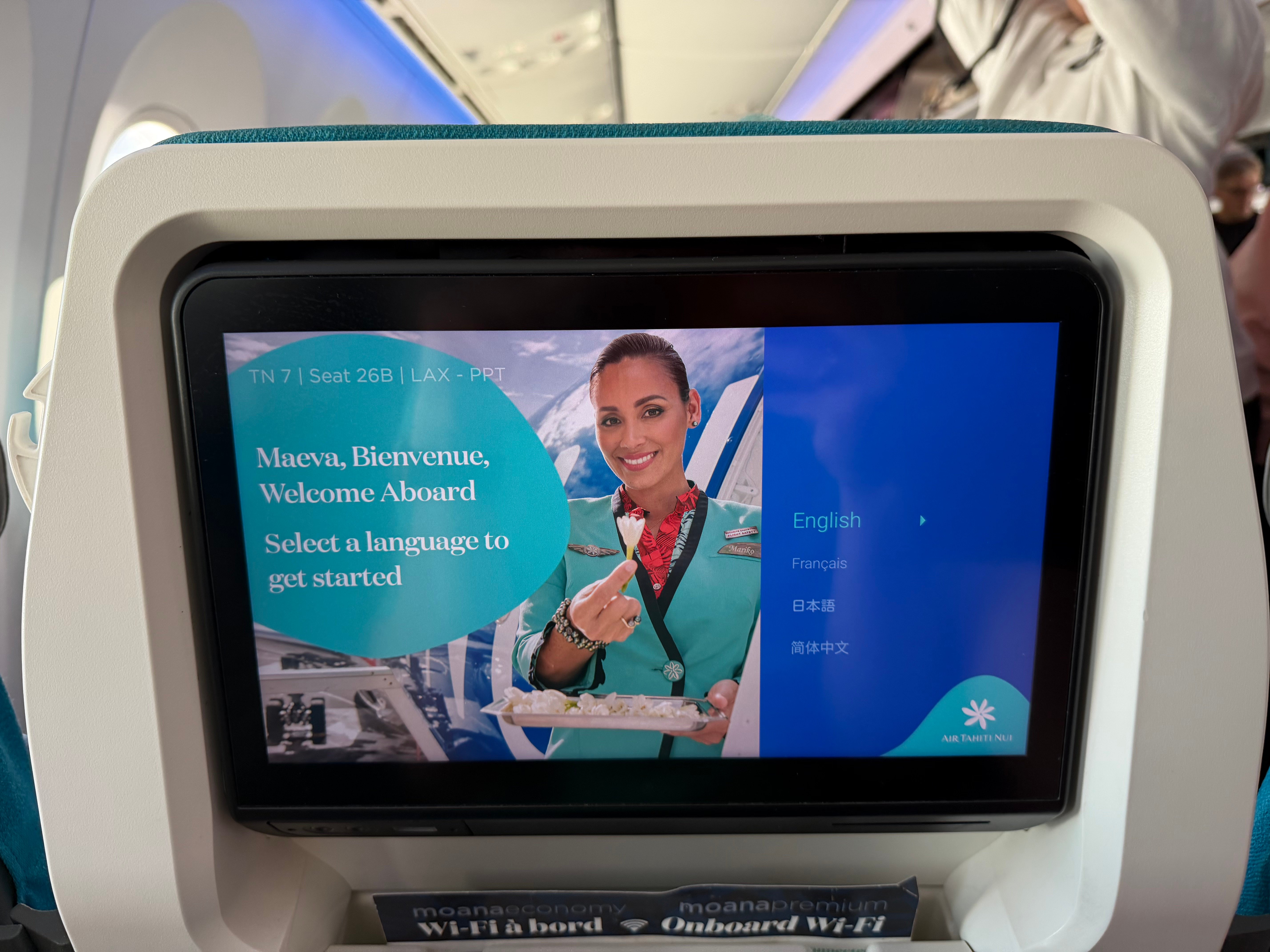 Air Tahiti Nui Moana Economy entertainment welcome screen at seat 26B.