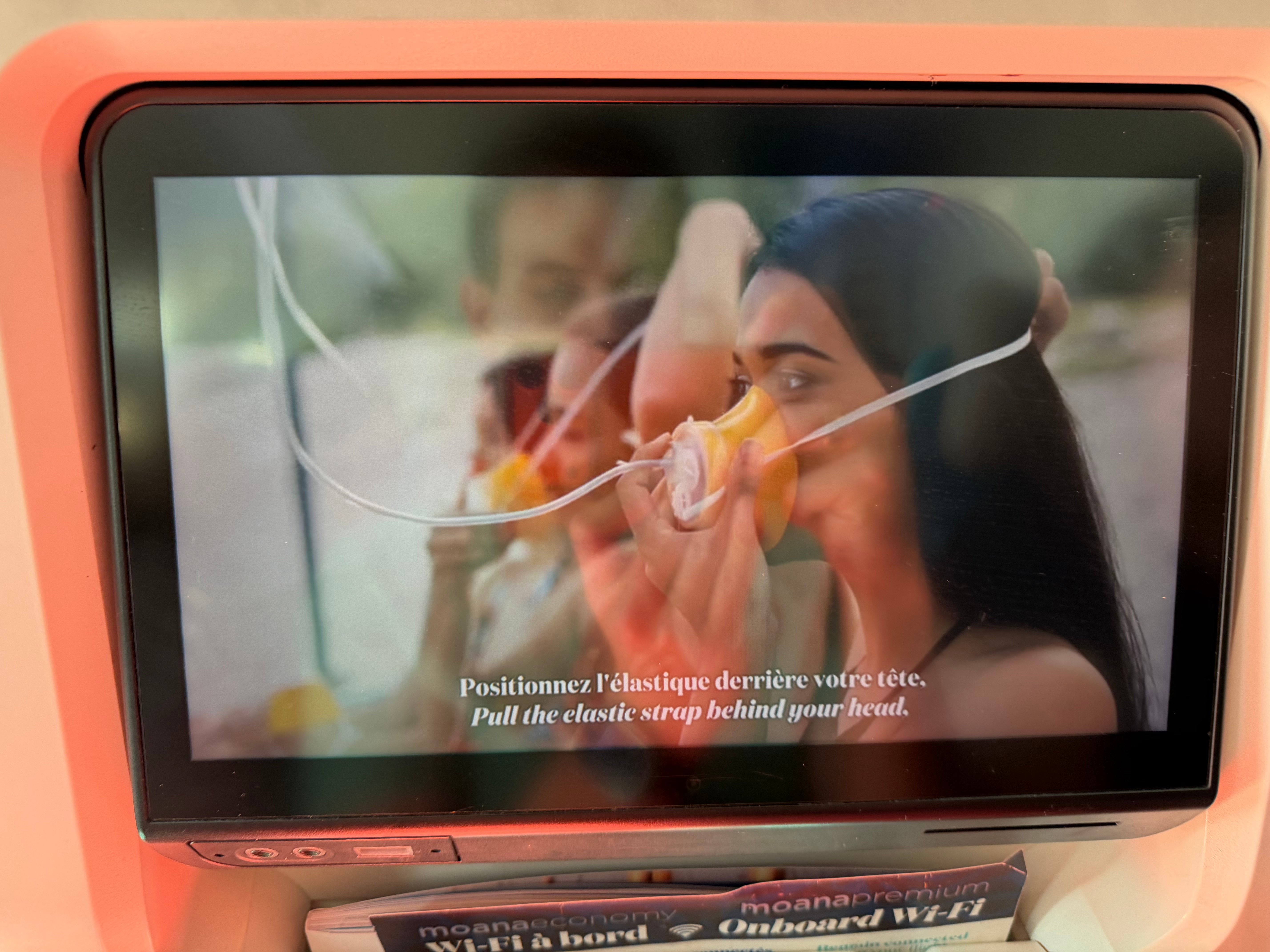 Safety video playing on the Air Tahiti Nui seatback screen before takeoff.