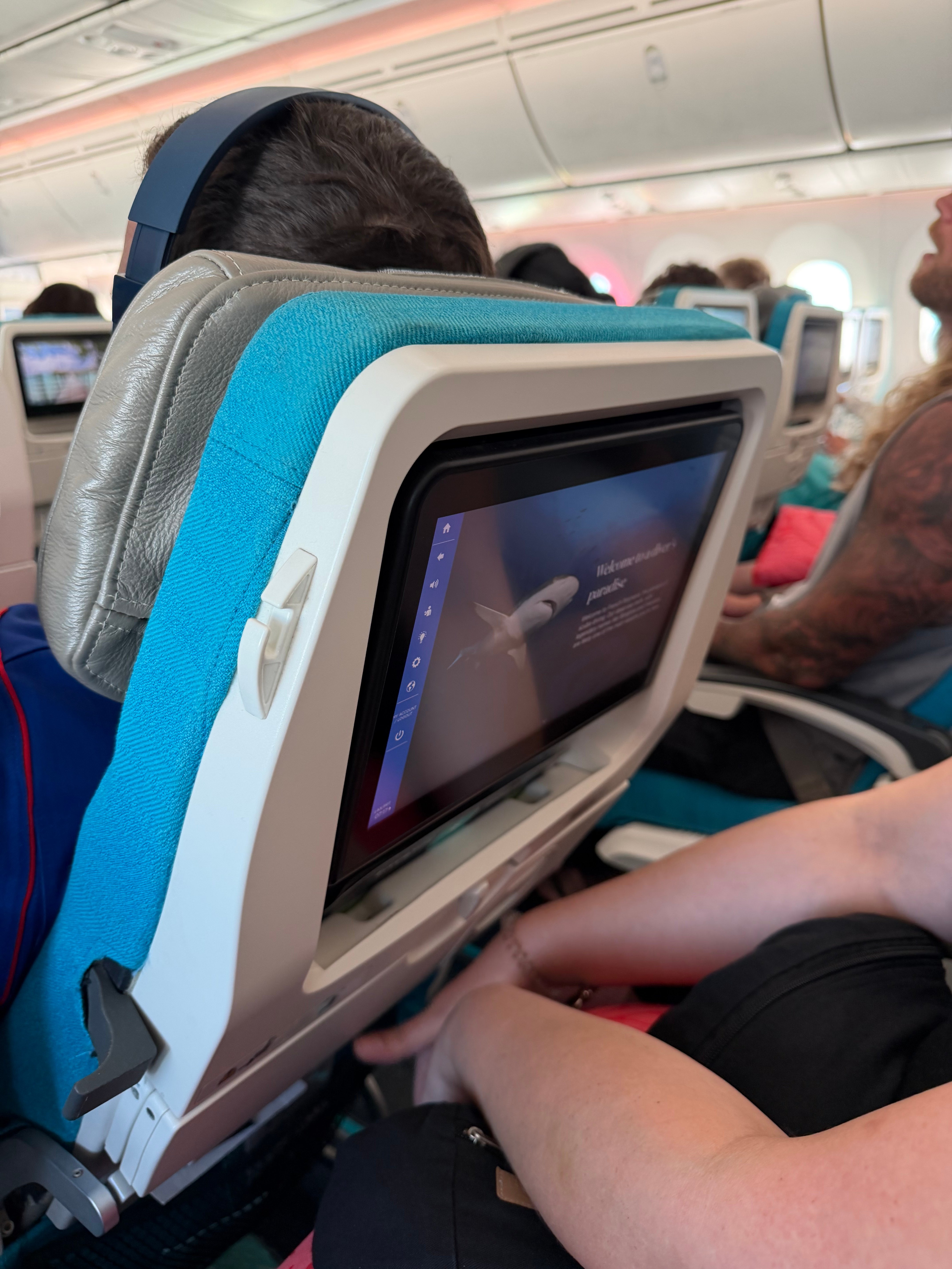 Side view of the fixed Air Tahiti Nui Moana Economy seatback screen.