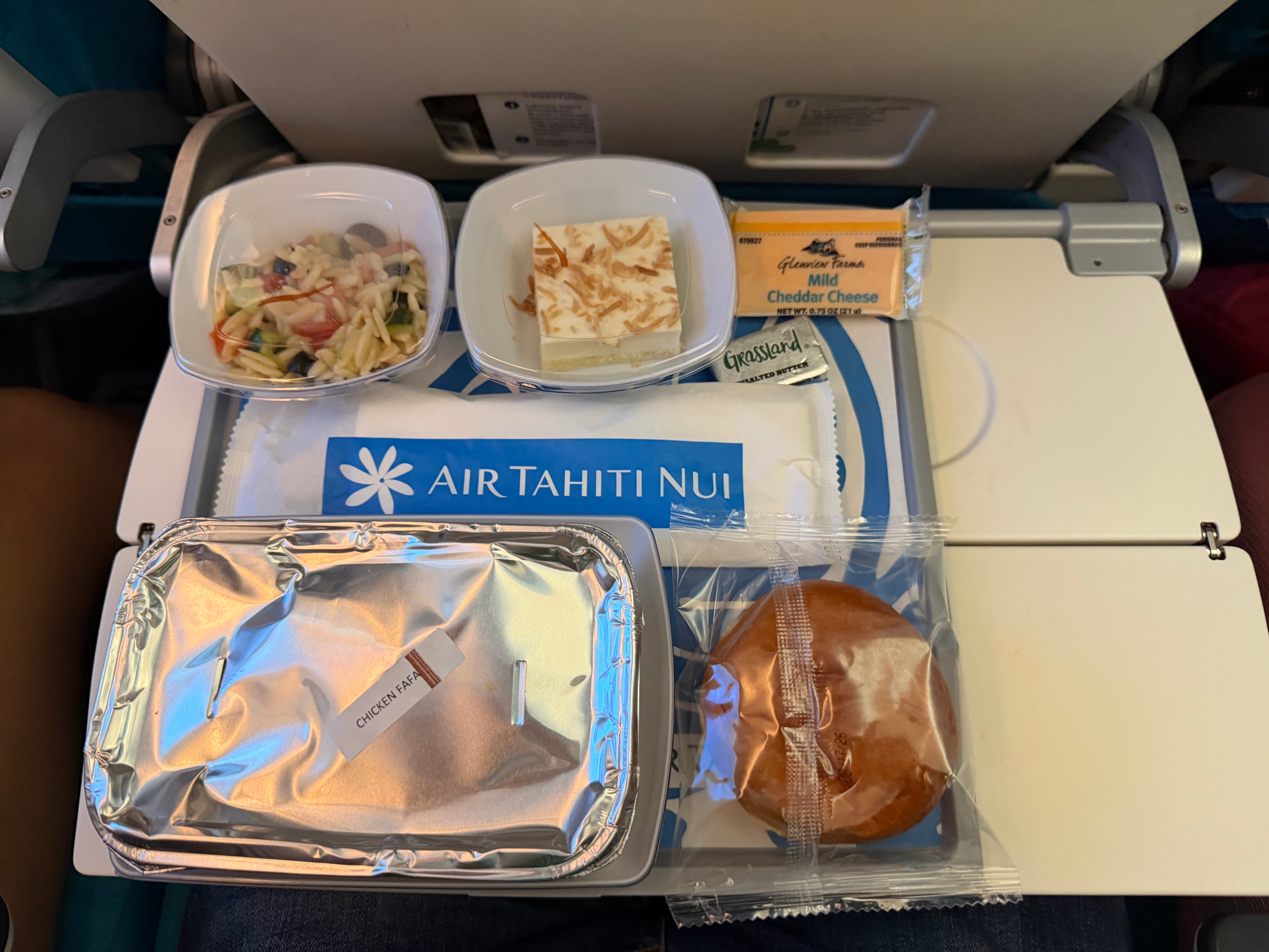 Covered dinner tray served in Air Tahiti Nui Moana Economy.