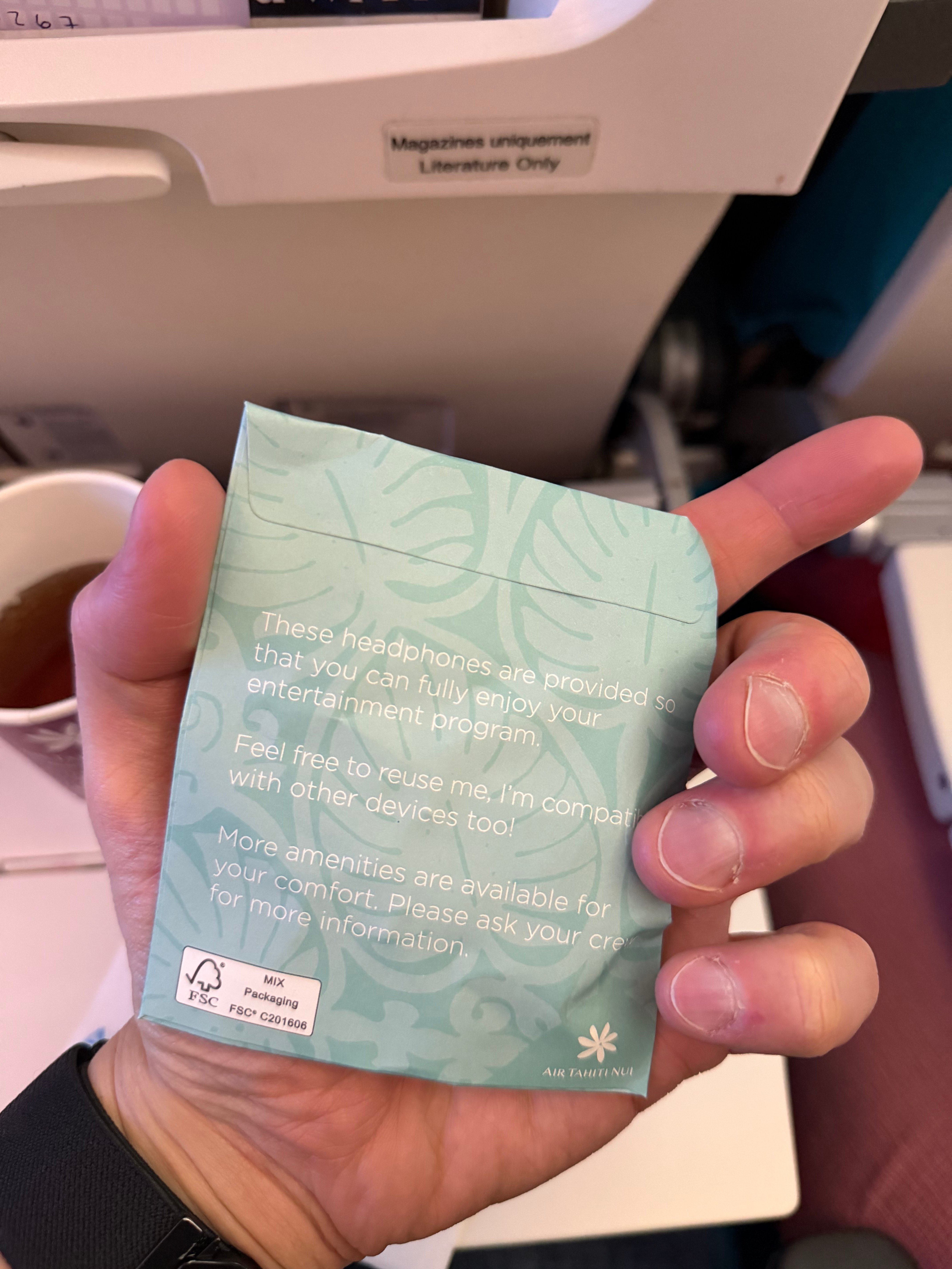 Instructions on the Air Tahiti Nui Economy earphones package.