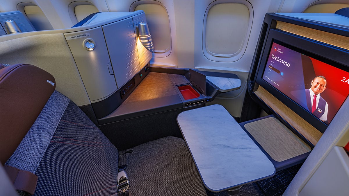 Window Flagship Suite on the American Airlines 777 with a large screen, side storage, and an extended tray table.