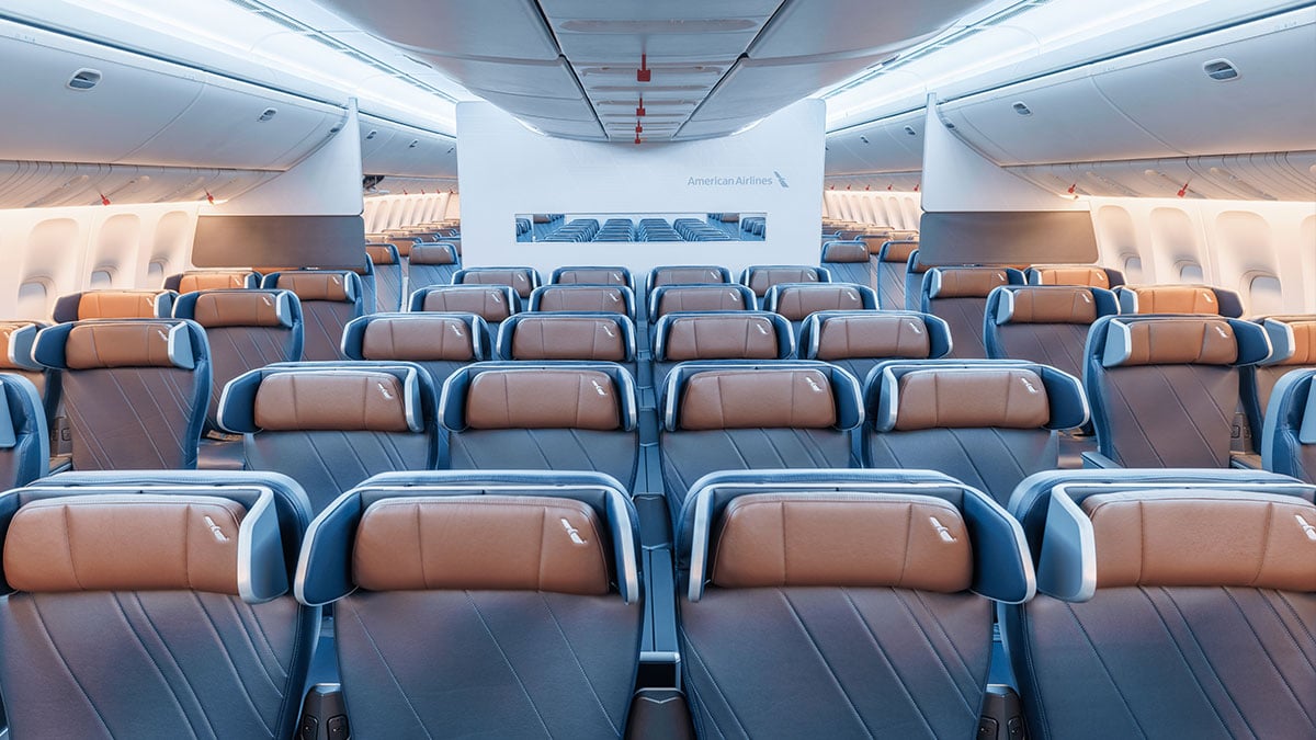 American Airlines refurbished 777 Premium Economy cabin with wide seats and winged headrests.