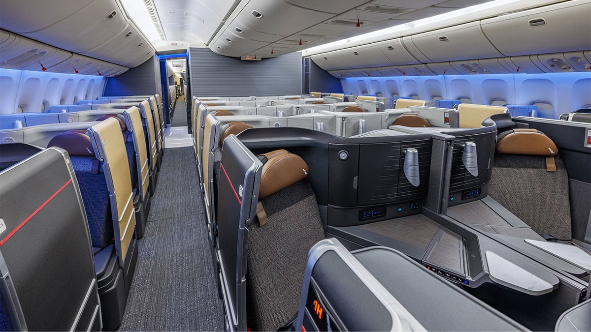 American Airlines refurbished Boeing 777 Flagship Suite cabin with individual window suites and paired center seats.