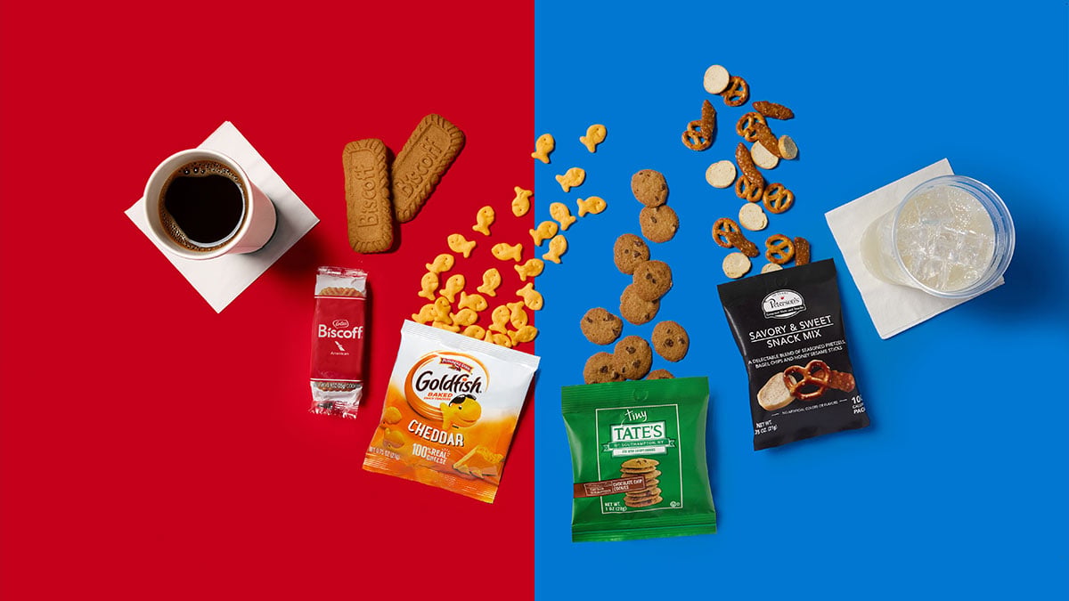 American Airlines snack selection with Biscoff cookies, Goldfish crackers, chocolate chip cookies, and savory and sweet snack mix.