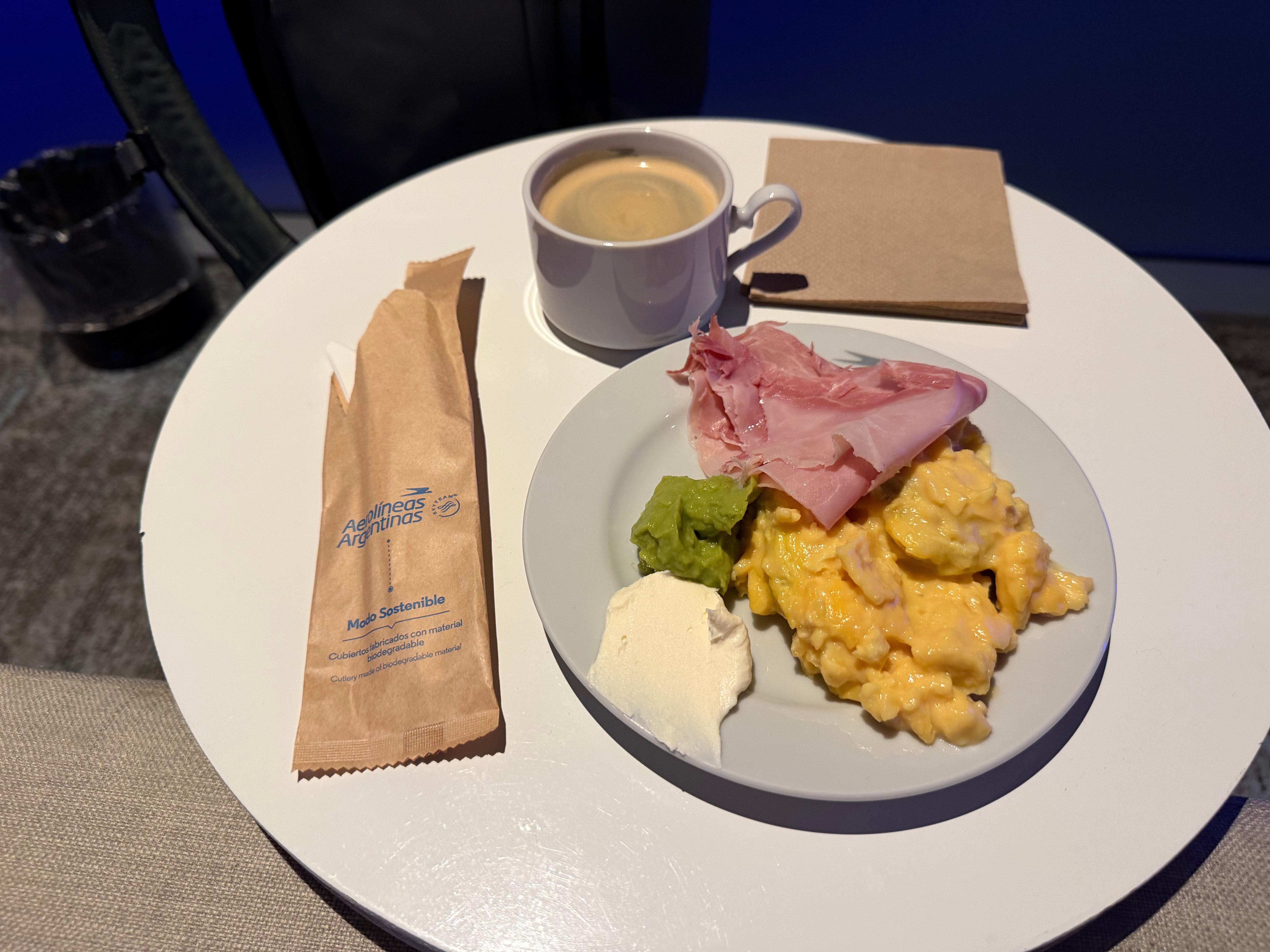 Breakfast plate with eggs, ham, cheese, and coffee in the Condor Lounge.