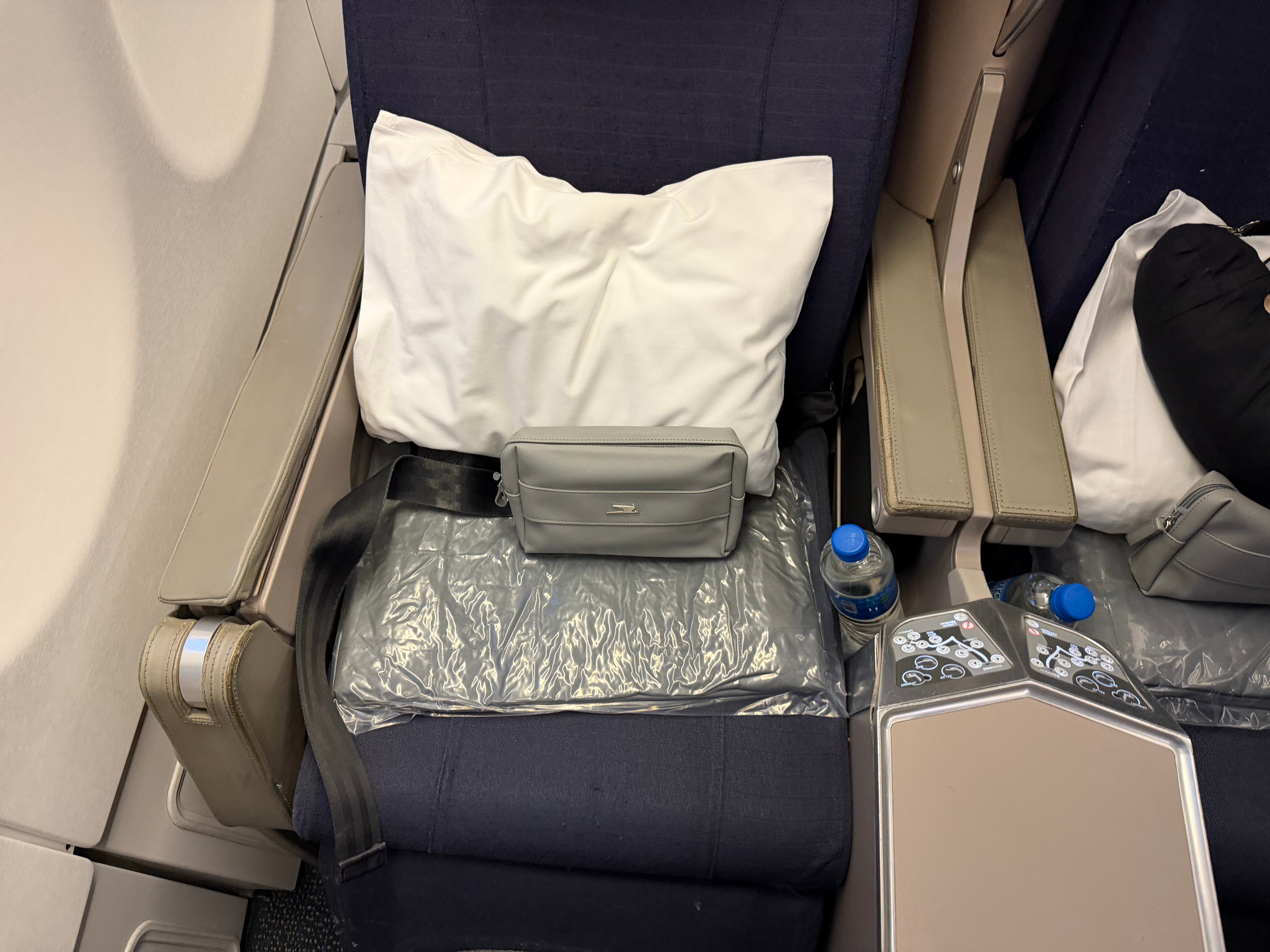 Close view of an Aerolíneas Argentinas A330 Business Class seat with its pillow and amenity kit.