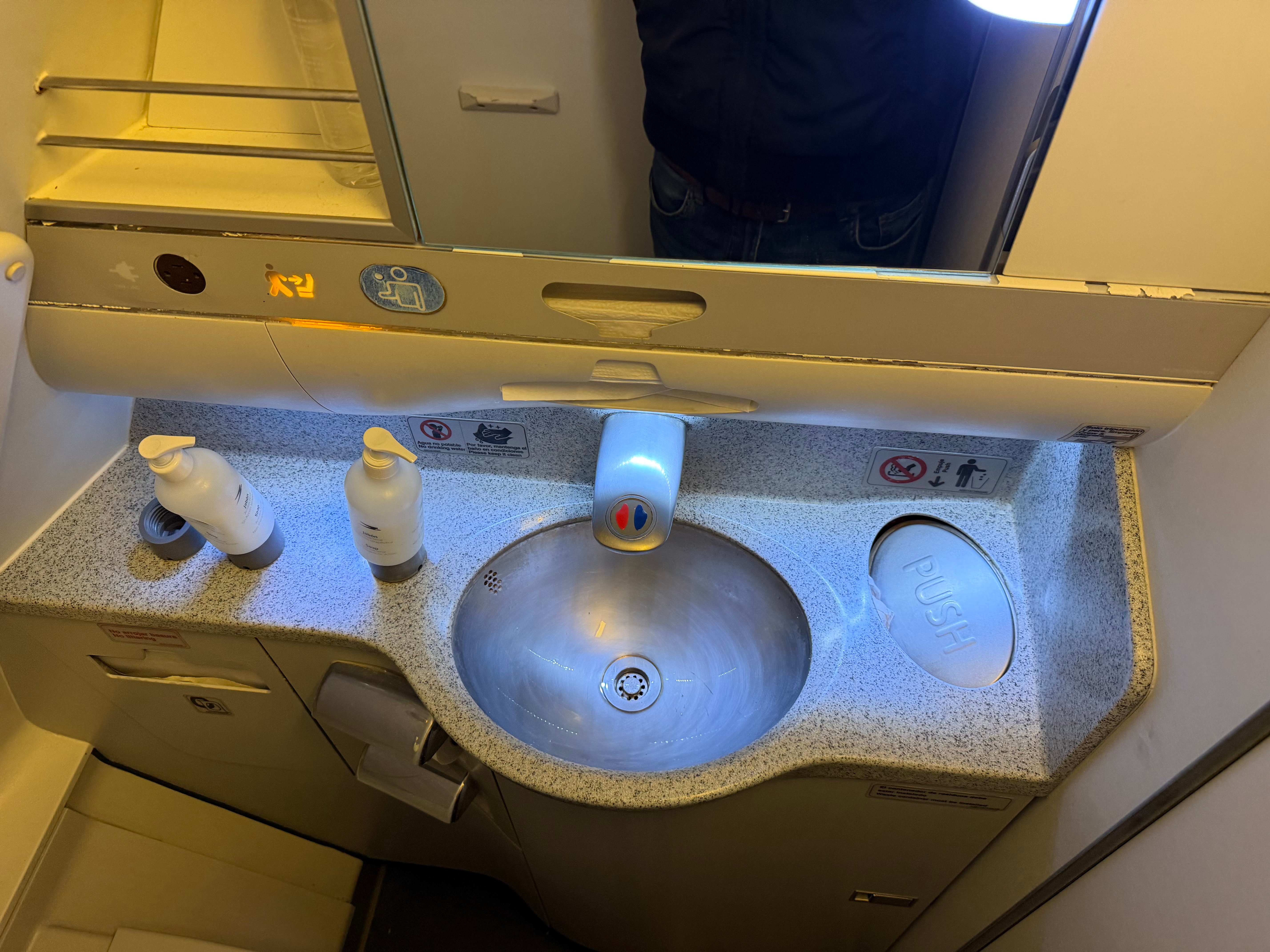 Sink and soap inside an Aerolíneas Argentinas Airbus A330 lavatory.