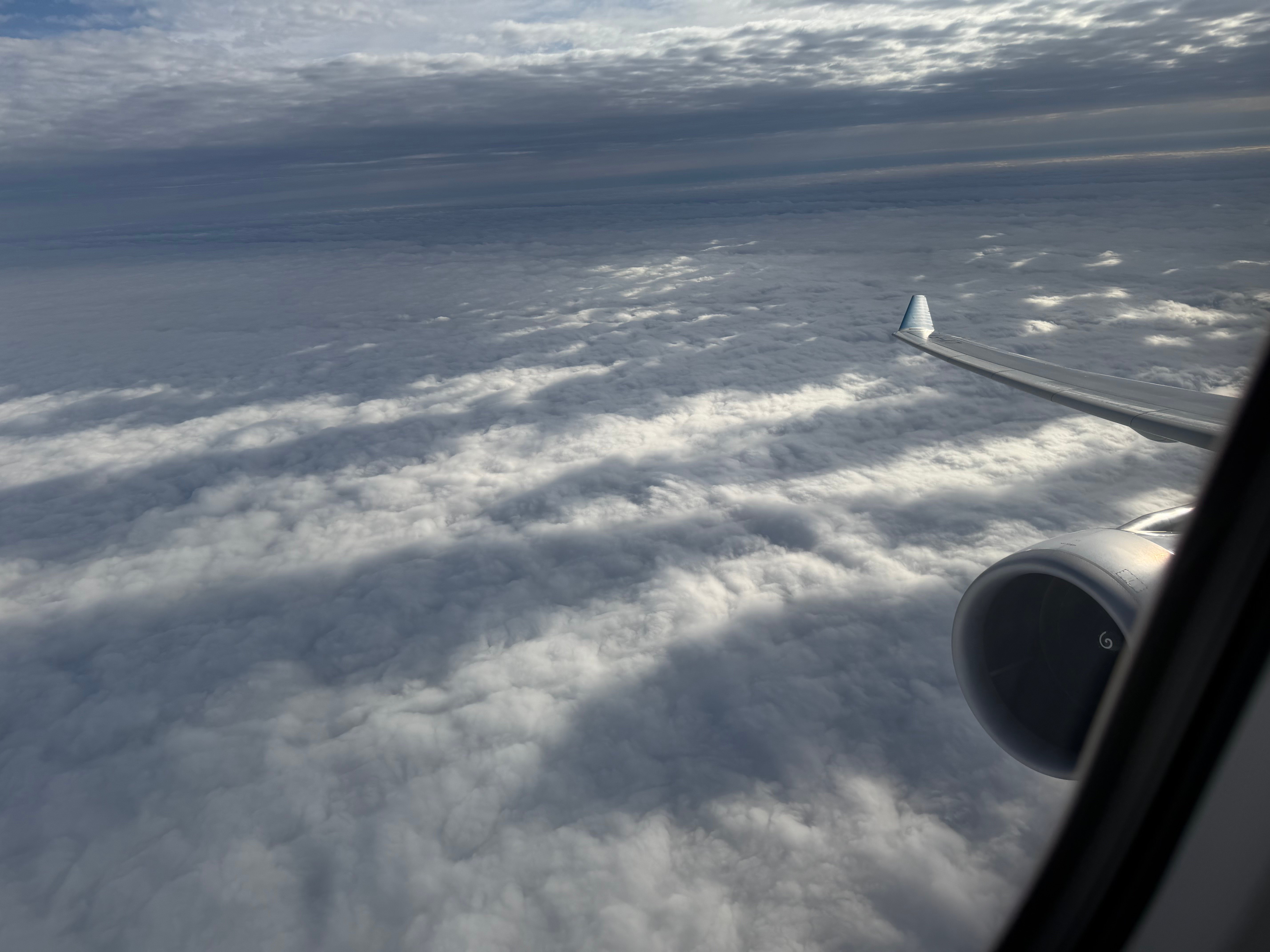 Airbus A330 wing and clouds after takeoff from Buenos Aires Ezeiza airport.