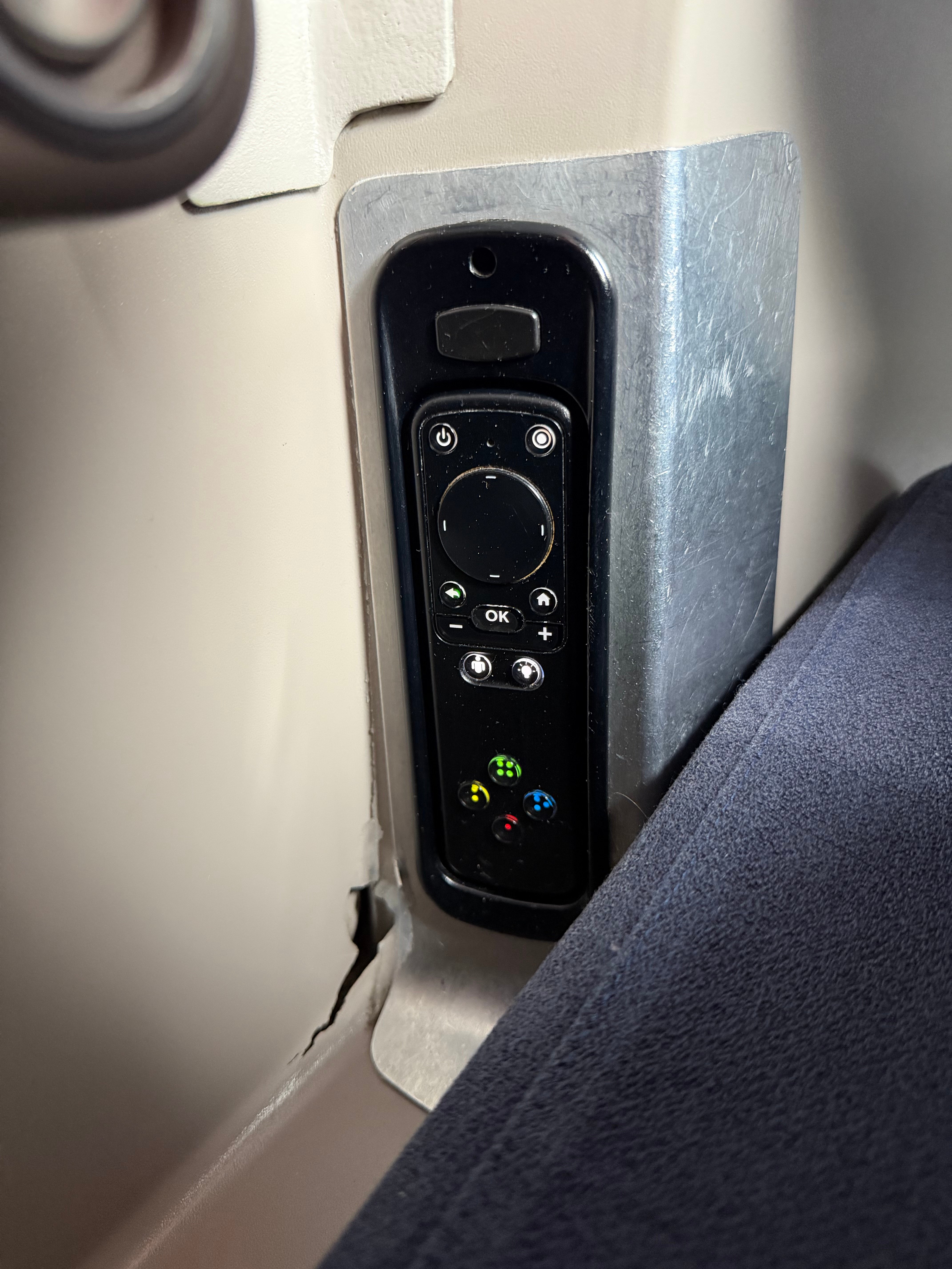 Inflight entertainment remote stored beside the Aerolíneas Argentinas Business Class seat.