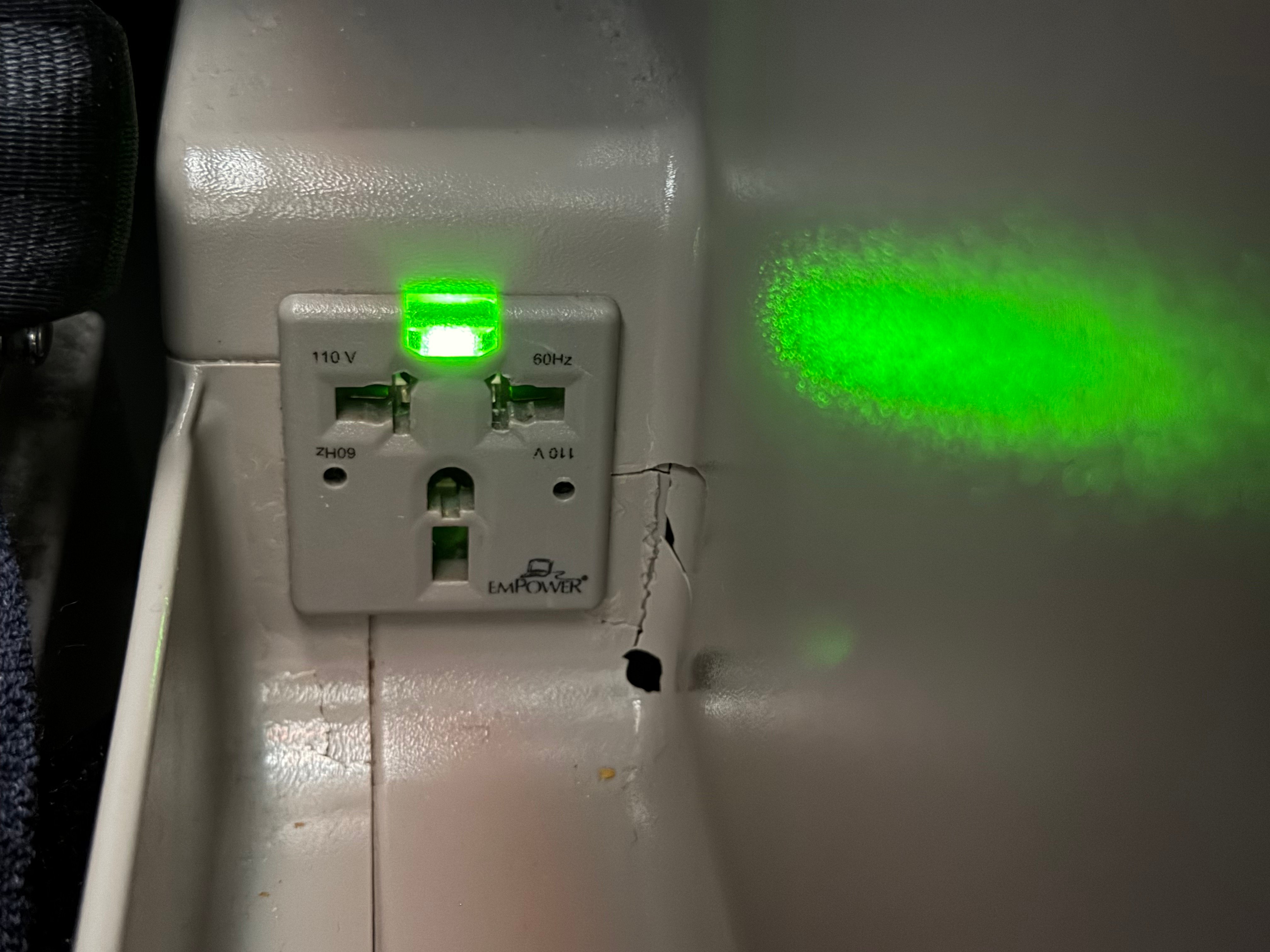 Close view of the power outlet in Aerolíneas Argentinas A330 Business Class.