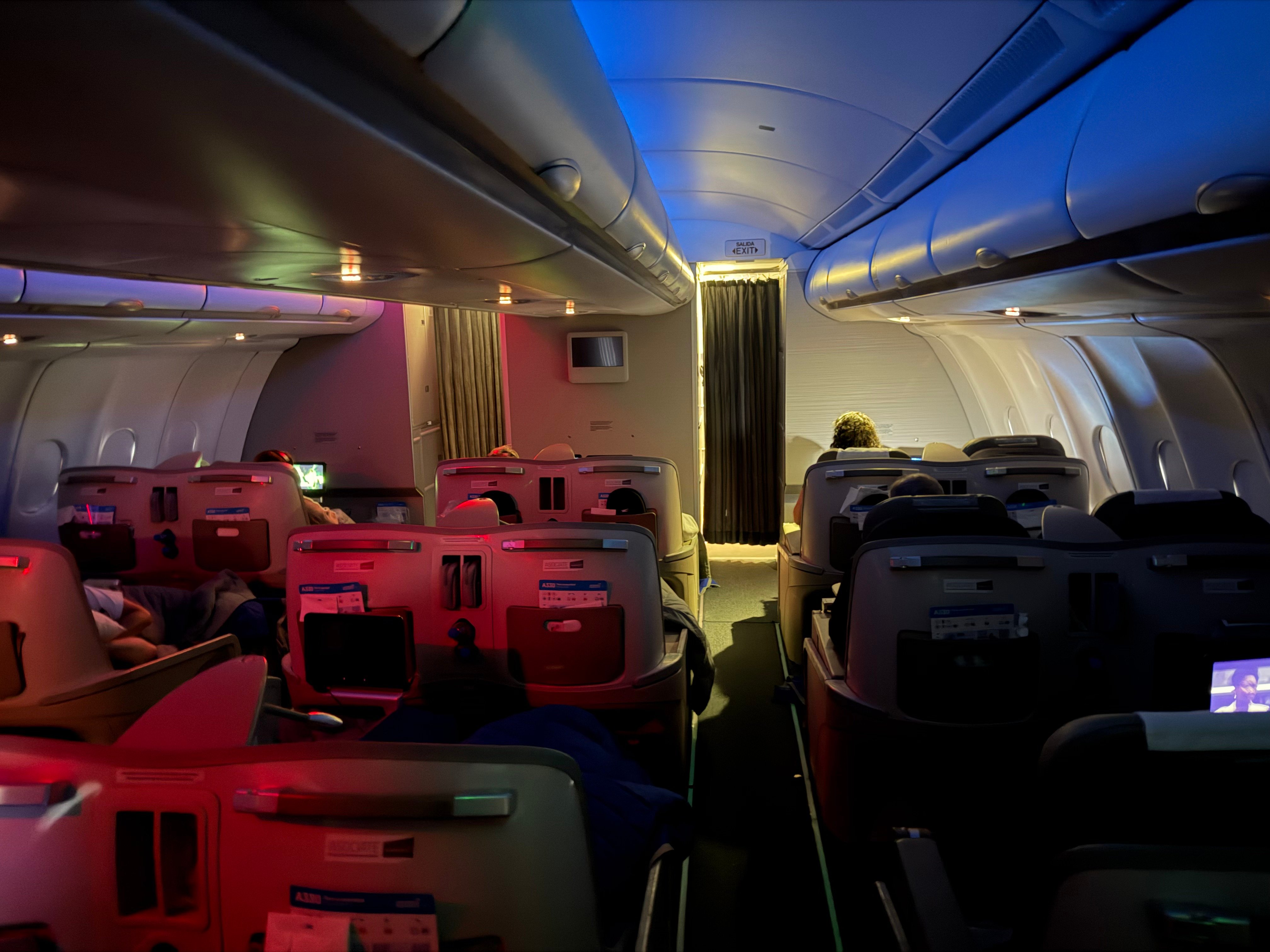 Aerolíneas Argentinas A330 Business Class cabin with the lights dimmed after lunch.