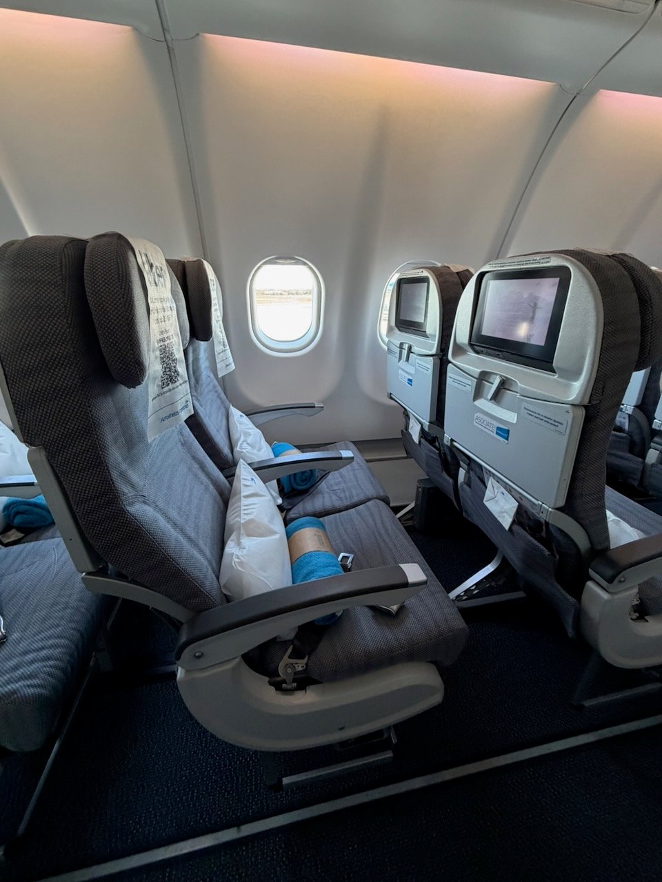 Legroom view from an Aerolíneas Argentinas A330 economy window row.