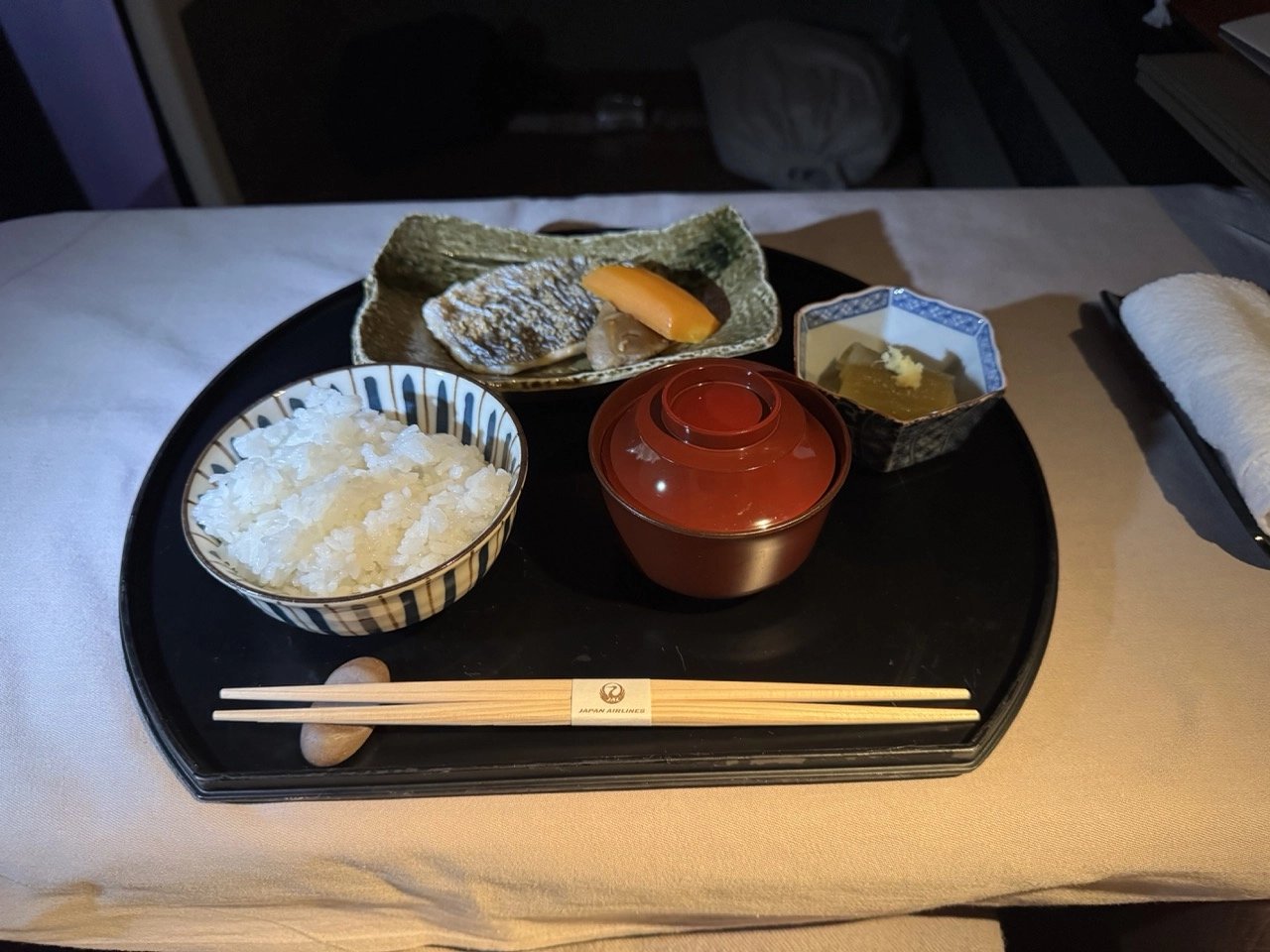 Japanese breakfast plate with grilled fish, rice, and miso soup