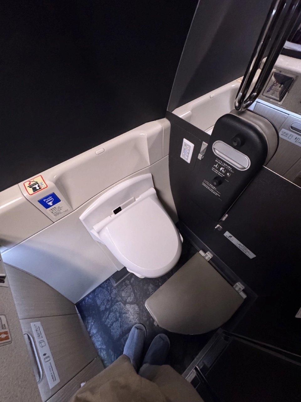 Inside the spacious JAL First Class restroom with bidet toilet