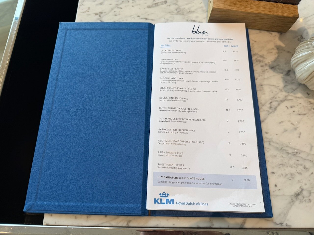Amsterdam KLM crown lounge blue bar drink list on the KLM Amsterdam to Buenos Aires review.