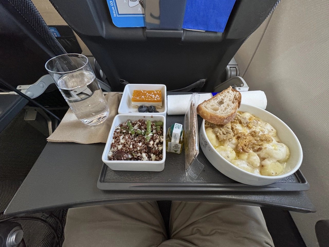 The full three-course meal served on a single tray with real porcelain.