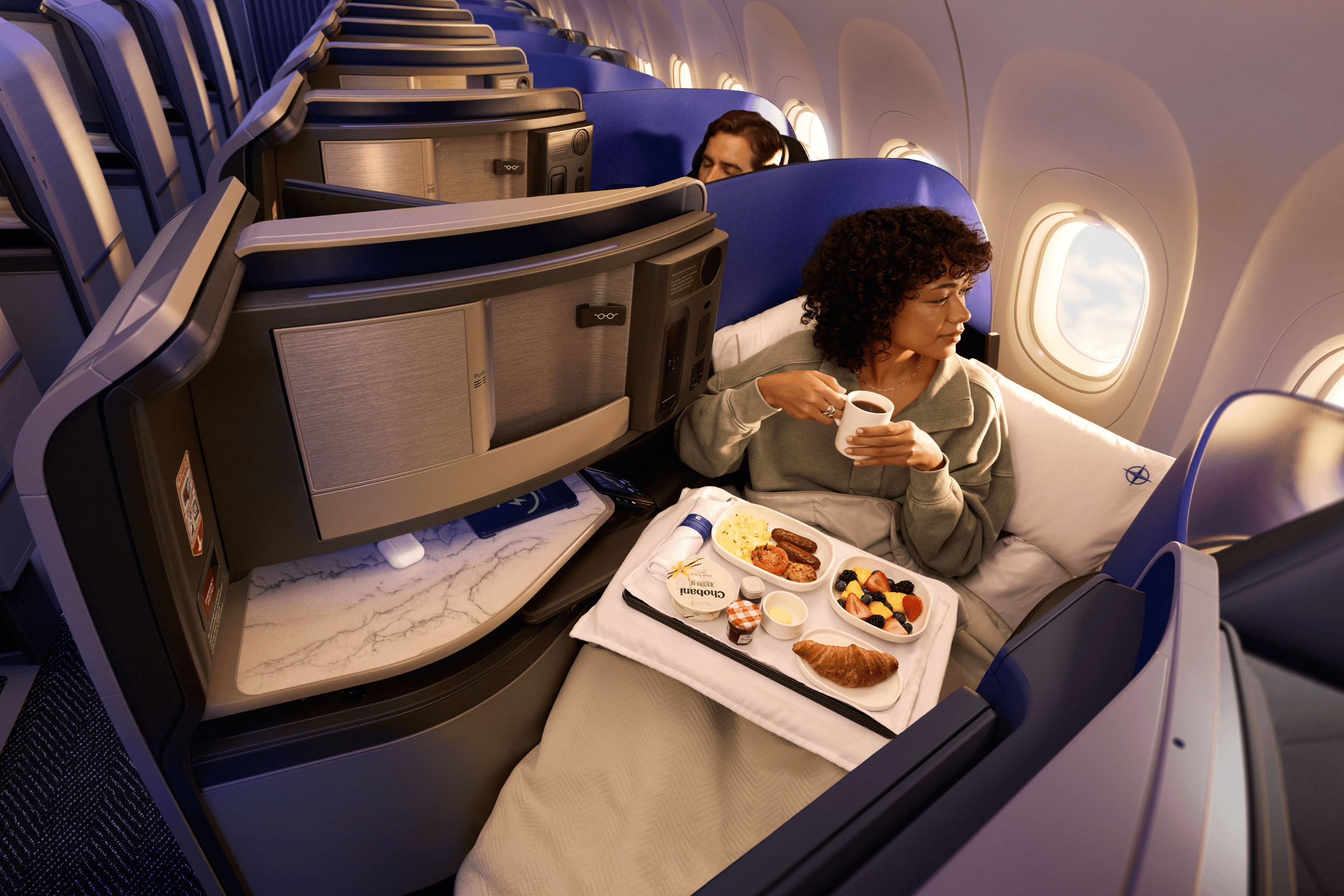 Passenger dining in a United Polaris suite aboard the Airbus A321XLR.