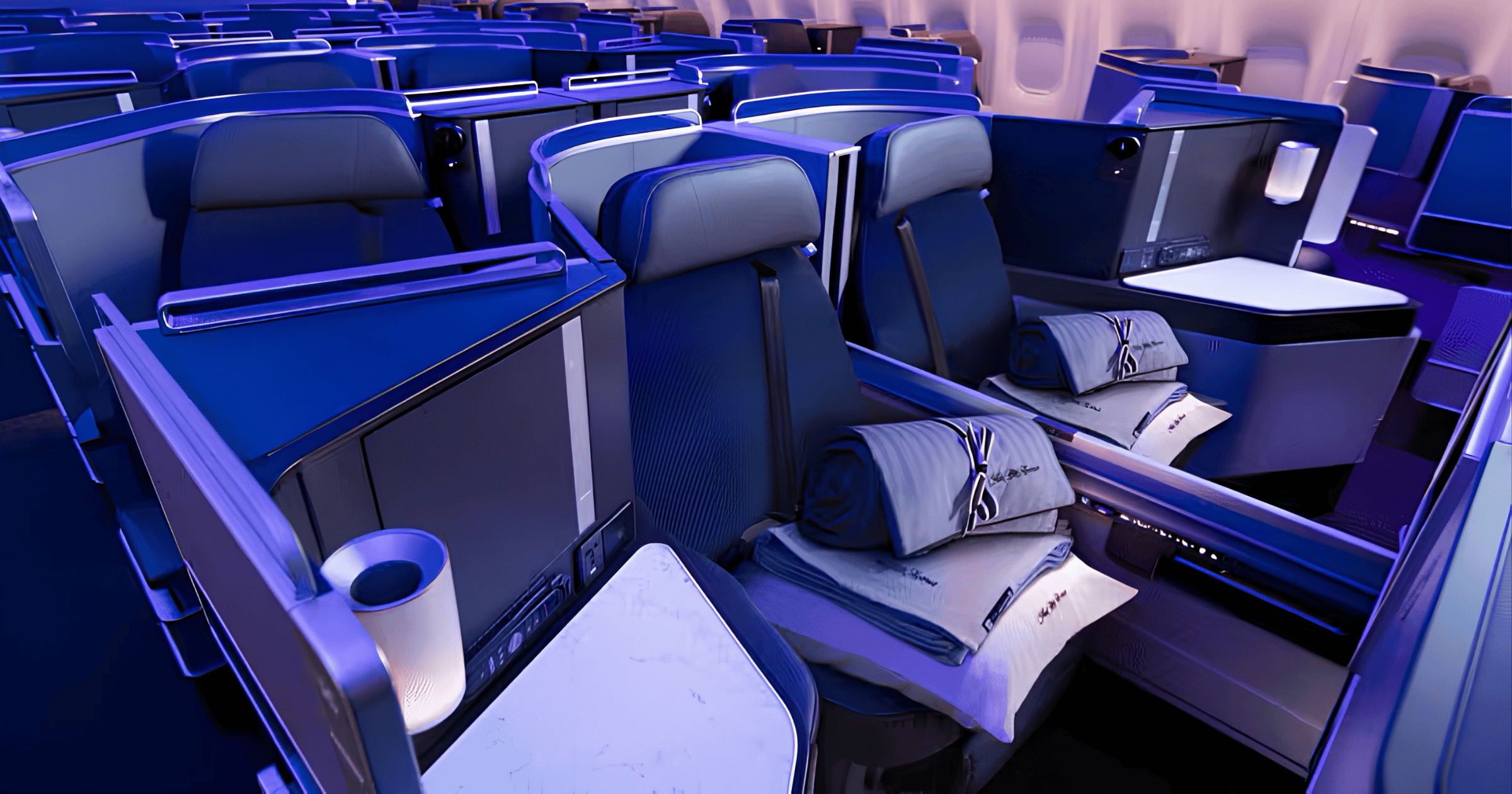 United Polaris business class seats with bedding and pillows on a United widebody.